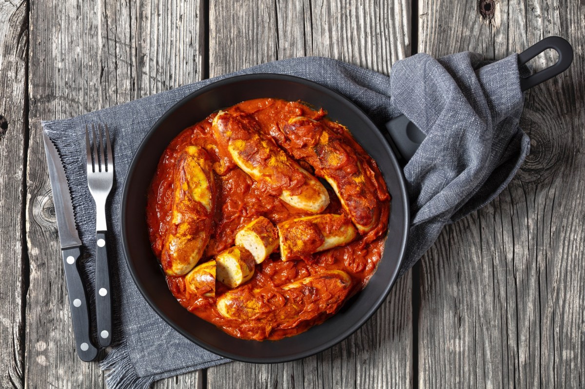 Sartén de currywurst con cubiertos al lado